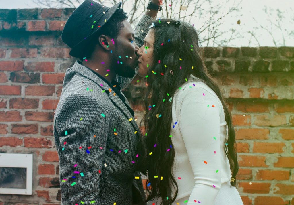 Canva - Man in Hat Kissing Woman in White Dress